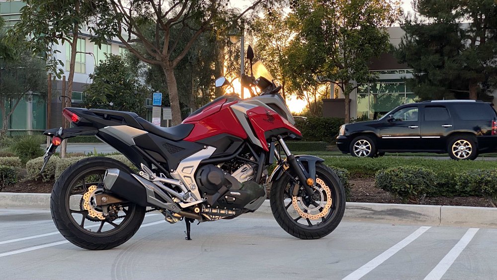 Honda NC750X with a black SUV driving by in the background.