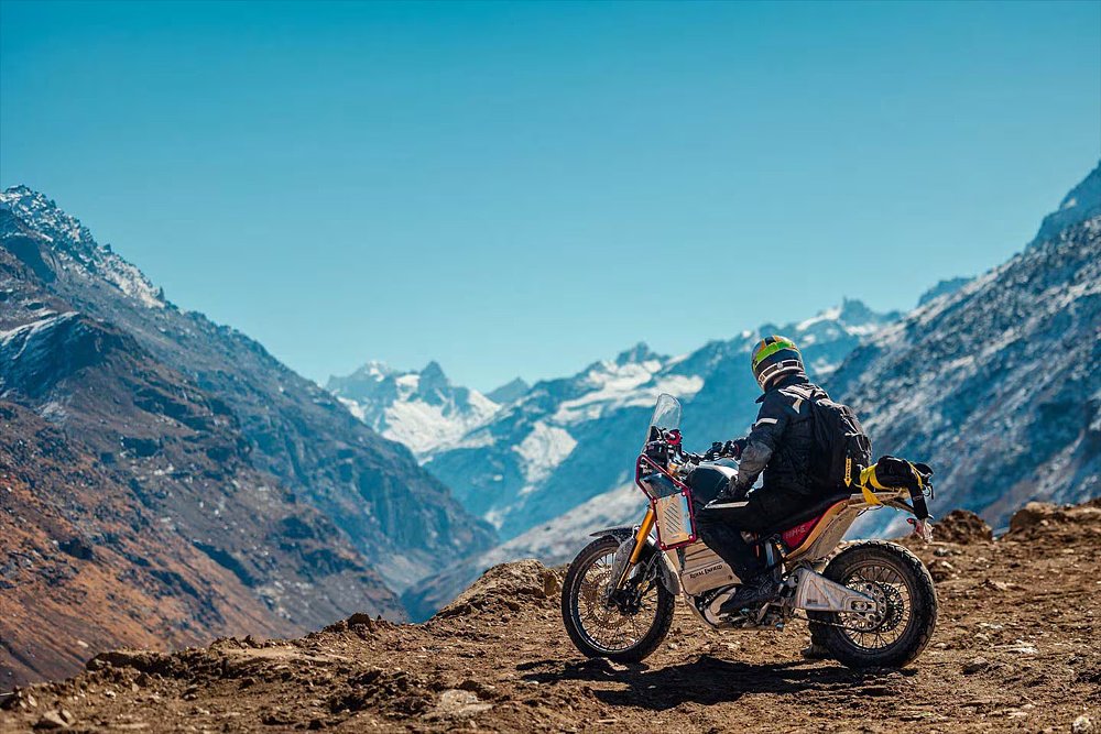 A lone rider takes in the Himalayan scenery mounted on the Royal Enfield Him-E concept.