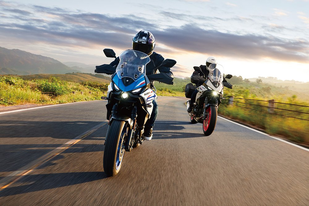 A pair of Suzuki SV-7GX riders tour a countryside road.