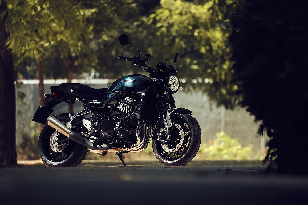 The 2026 Kawasaki Z900RS photographed under the shade of trees.