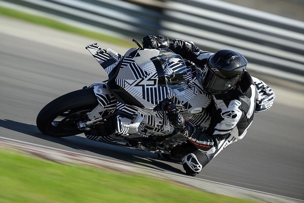 A rider sends the CFMOTO V4 SR-RR through a curve on track.
