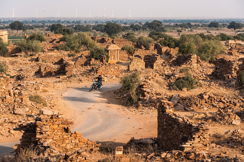 overhead view of a rider on a twisting lane through ancient ruins