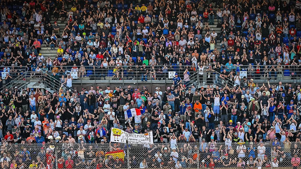 A wide photo of the packed stands at France's Le Mans circuit.