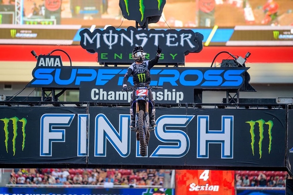 Cooper Webb flies over the jump at the finish line of the Supercross race in Salt Lake City in 2025 to win the championship