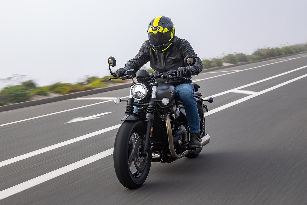 Dustin rides the Bobber down a beachside street.