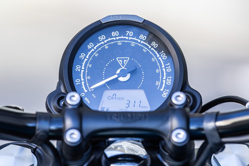 A close-up of the Bobber's analog speedometer and LCD screen.