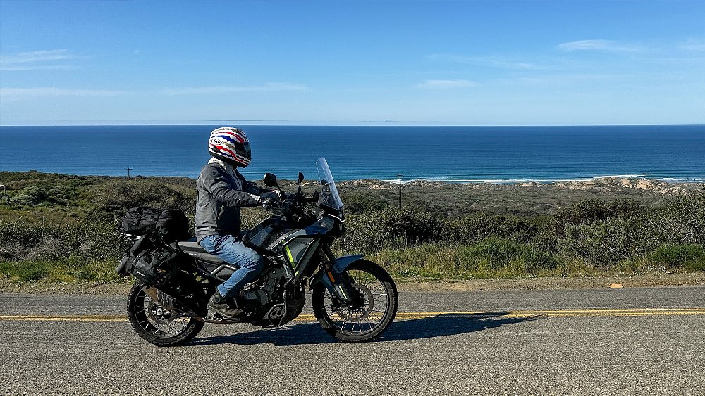 Dustin rides the Ibex 450 along a beachside road.