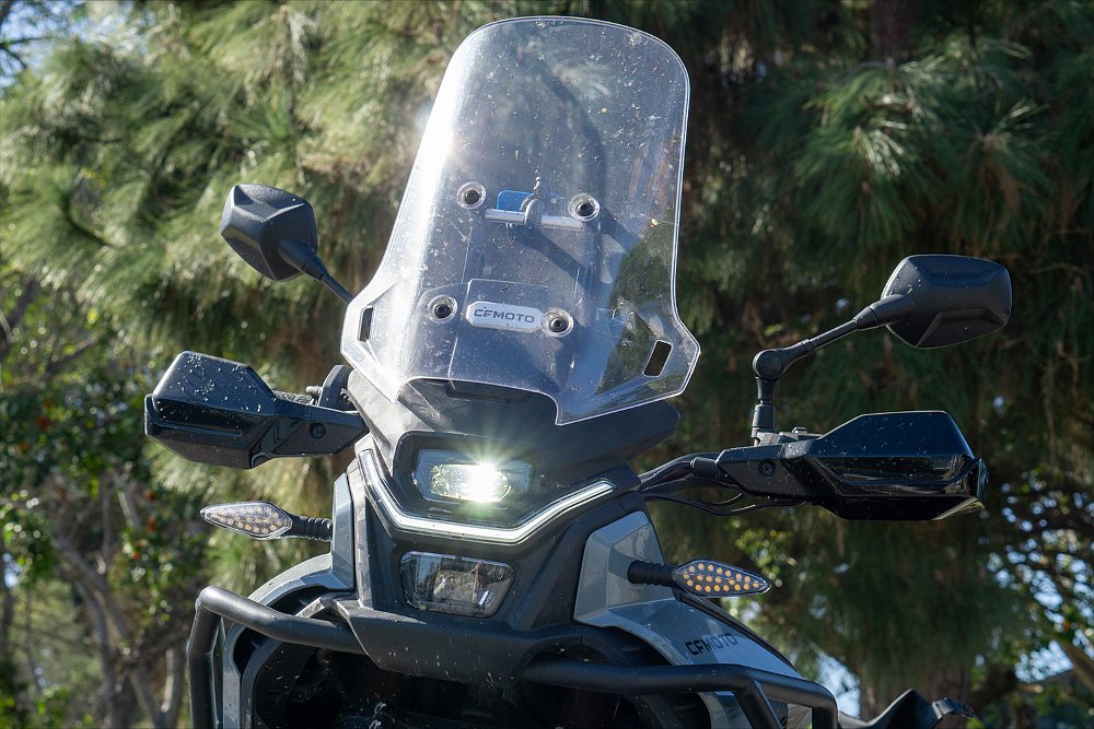 A close-up of the Ibex 450's bug-splattered tall windscreen.