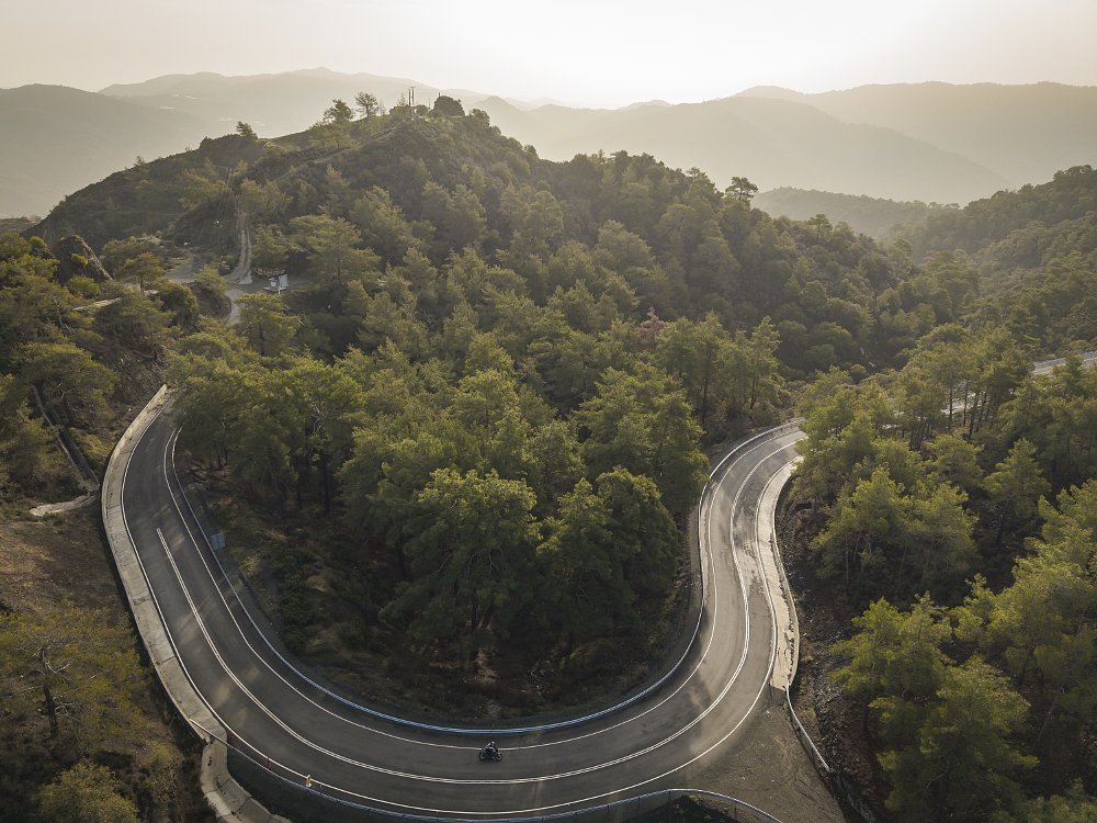aerial view of riding the Trident 800 on a forested road in Cyprus