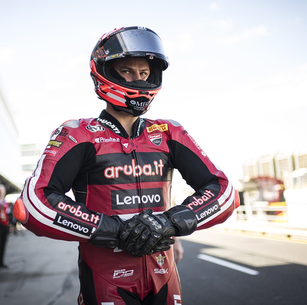 Bulega in helmet and gear waiting to get on his bike at Phillip Island
