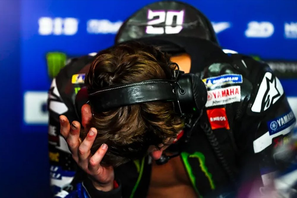 Fabio Quartararo holds his head in his hands out of sheer frustration.
