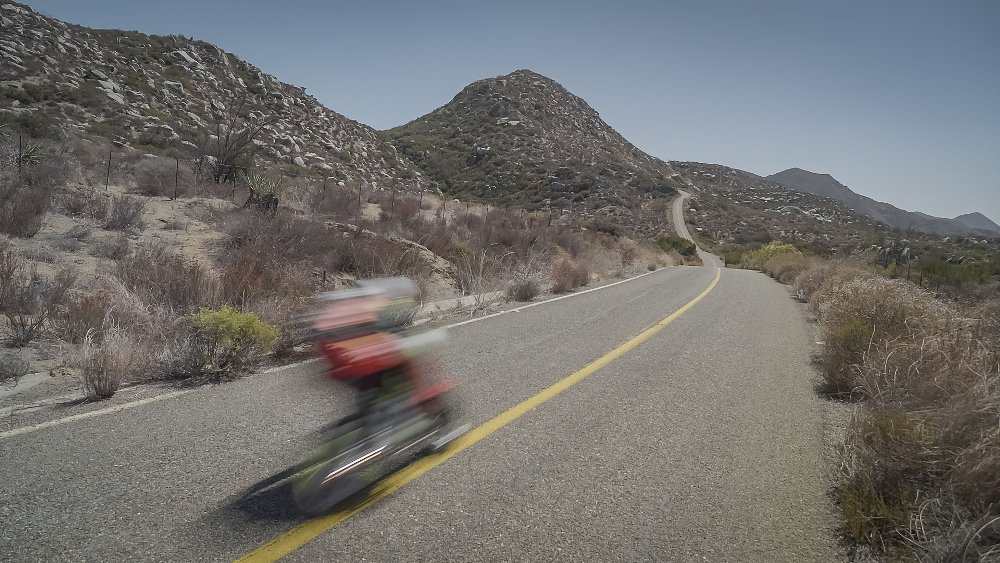 A Honda Grom flashes past the camera, racing up a closed road at the San Pedro Martir Hill Climb.