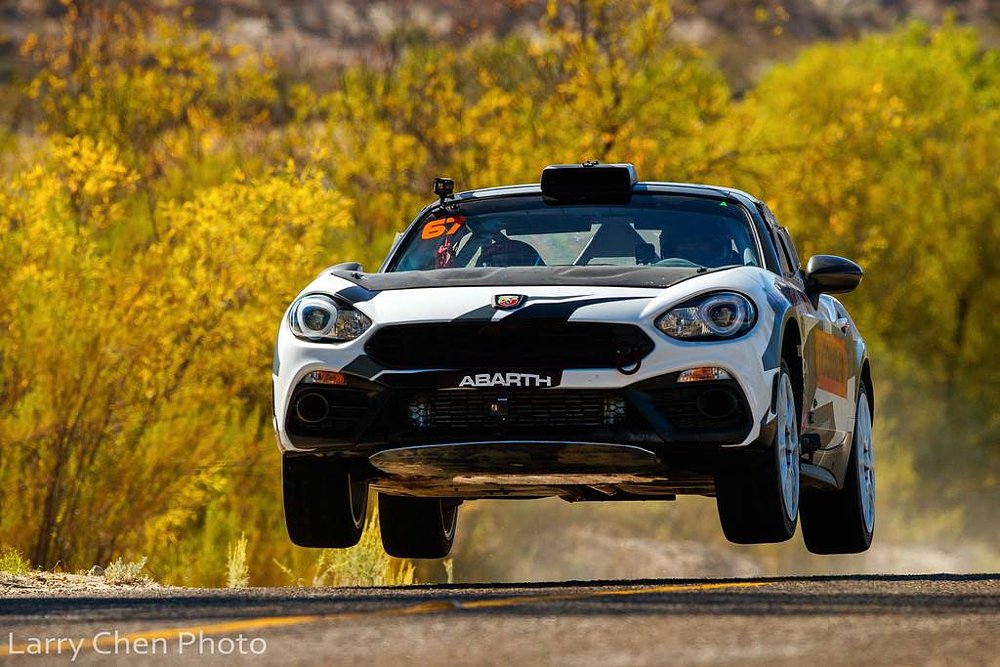 A Fiat jumping over a rise in the road at the San Pedro Martir Hill Climb.