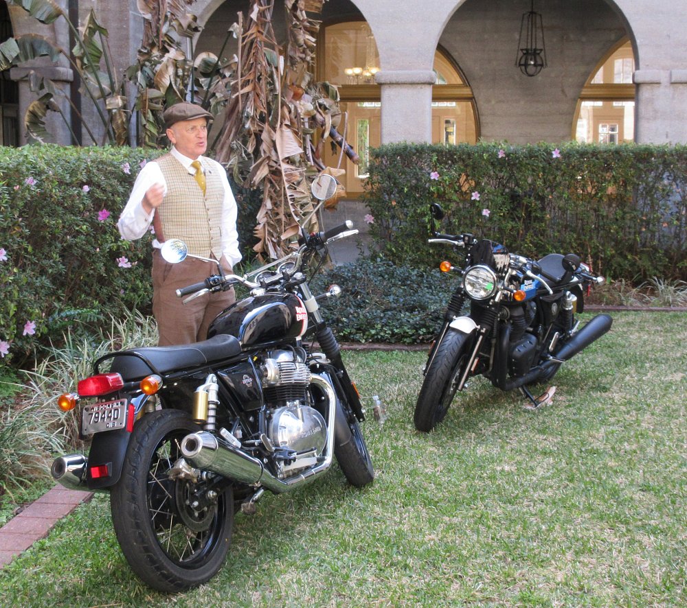 Gordon May explaining two of the modern Royal Enfield twins on the lawn of the museum