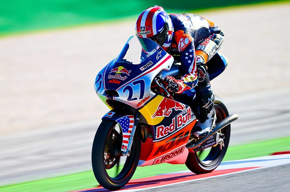 A 14-year-old Joe Roberts fires his Red Bull Rookies Cup bike down the straight.