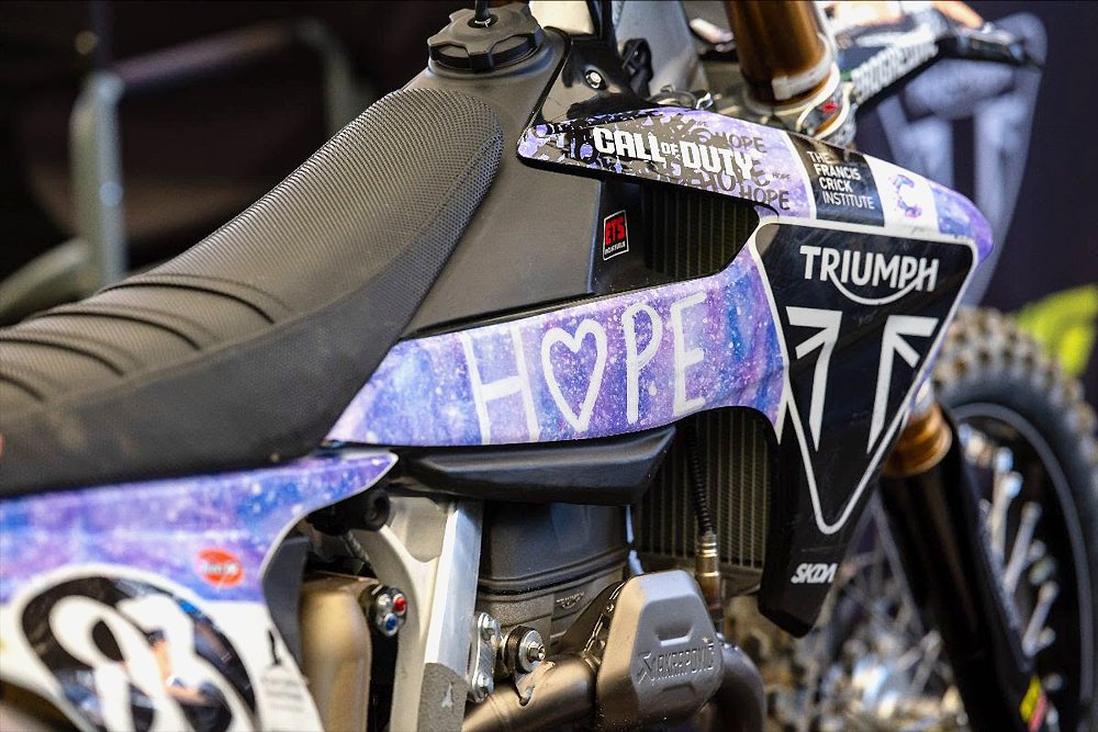 A close-up of a Supercross race bike with St. Jude's patient artwork decorating its plastics.