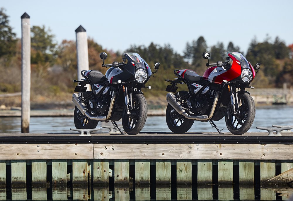 two Thruxton 400s parked on a pier, one black and one red