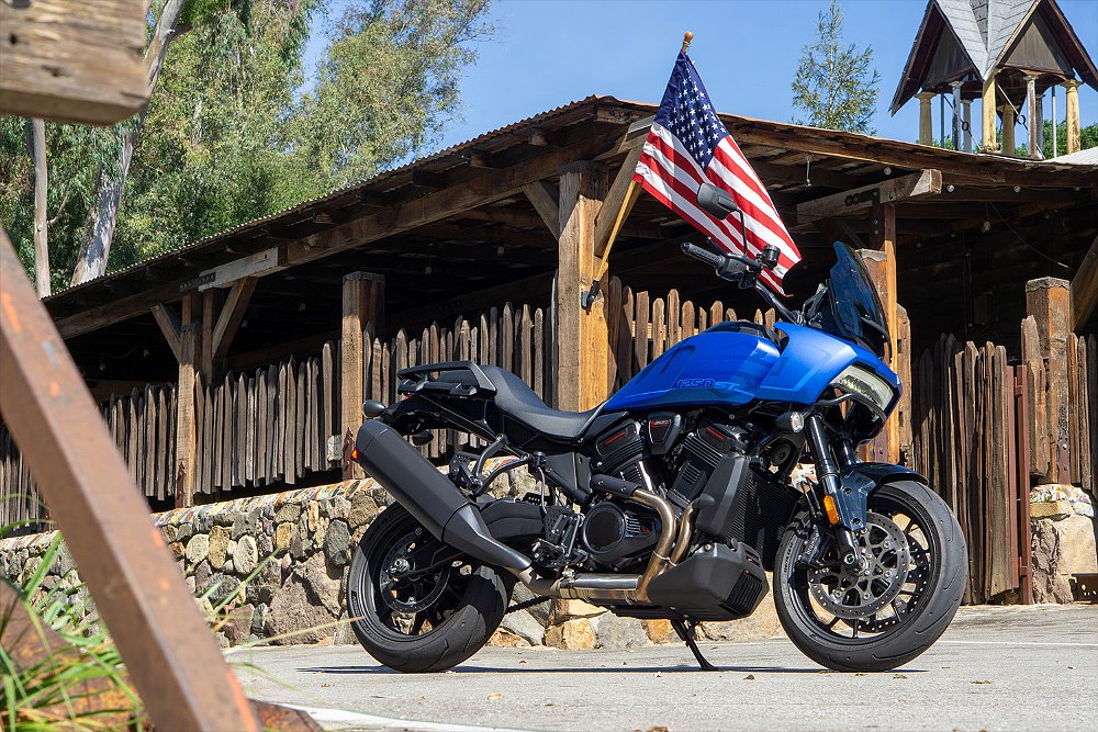 The Pan America ST parked in front of a ranch house bearing a U.S. flag.