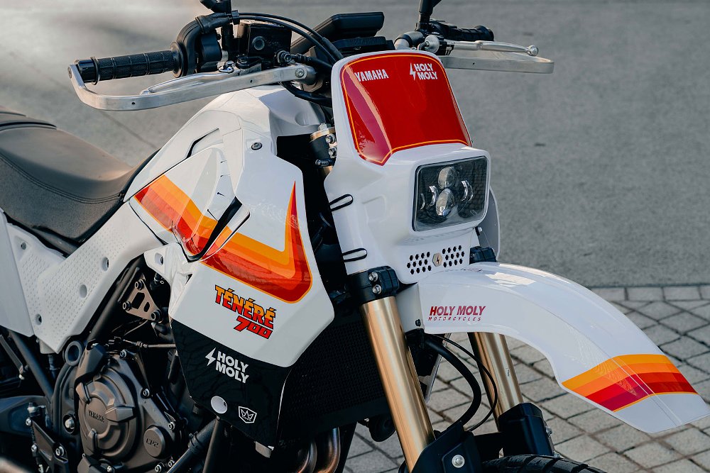 close view of the front of the modified motorcycle, white with red and orange stripes