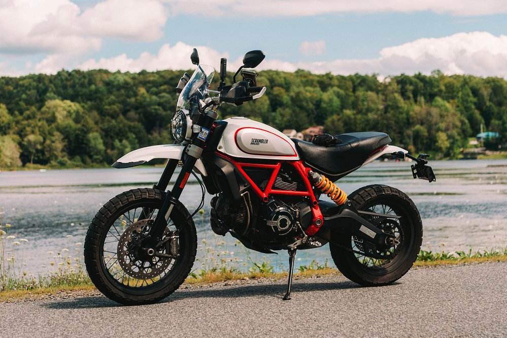 side view of the red and white Desert Sled parked by a lake