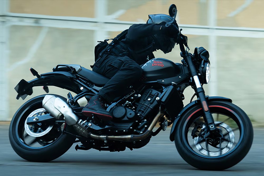 A rider bends the Guerrilla 450 Apex through a turn on a city street.