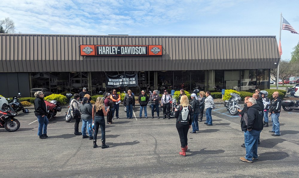riders gathered outside a Harley-Davidson dealership for a pre-ride meeting