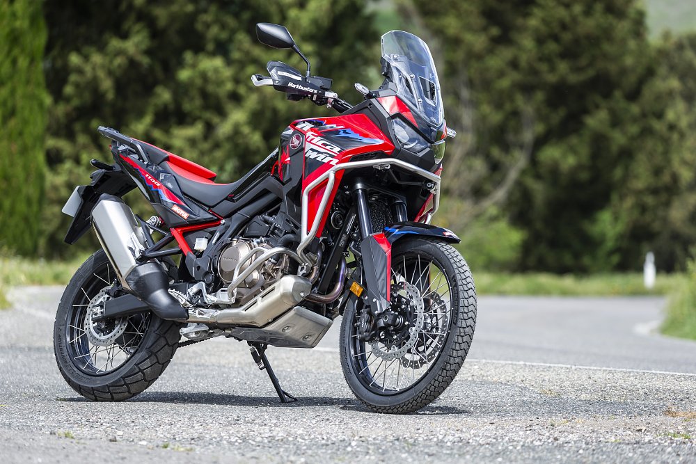red white and blue Honda Africa Twin on a country lane