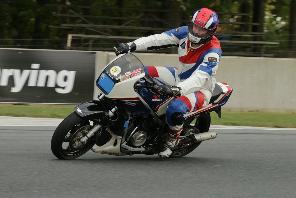 the rider going through a corner on his VF750F with upright body position and footpage nearly scraping the pavement