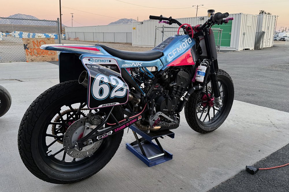 rear three-quarters view of the blue and pink race bike