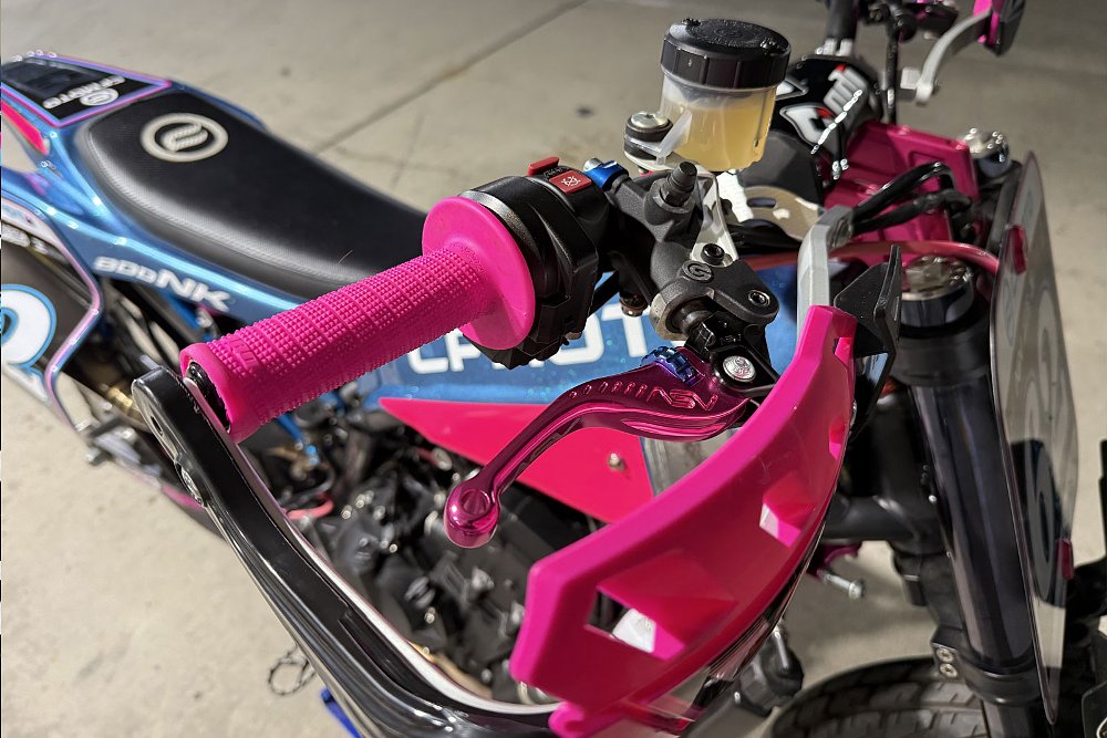 close view of righthand controls on the race bike with pink grips