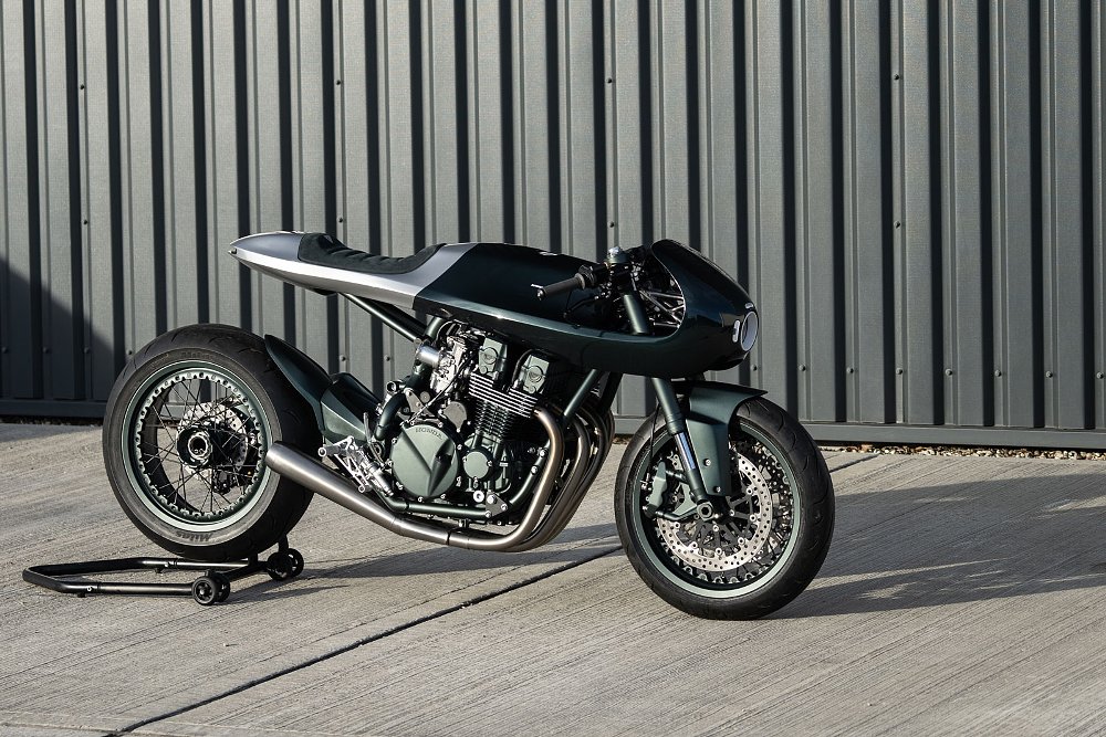 black custom cafe racer style motorcycle with swoopy bodywork, side view