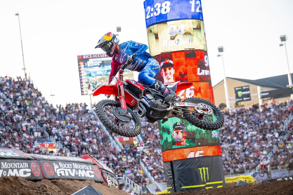 Lawrence on his Honda flying past a scoring pylon showing him second behind Roczen