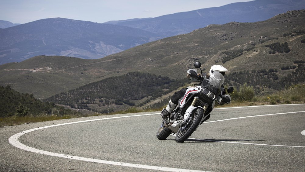 rider on a DesertX on a curve in a paved mountain road