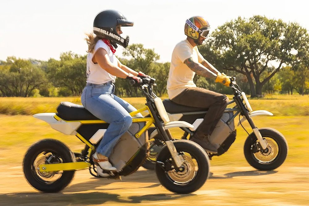 Two motorcyclists ride the LiveWire S4 Honcho through a field.