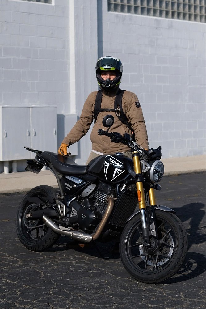 Jacob stands beside his Triumph Speed 400.