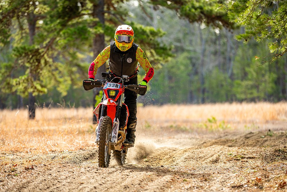 Ricky rides his dirt bike around the racecourse.
