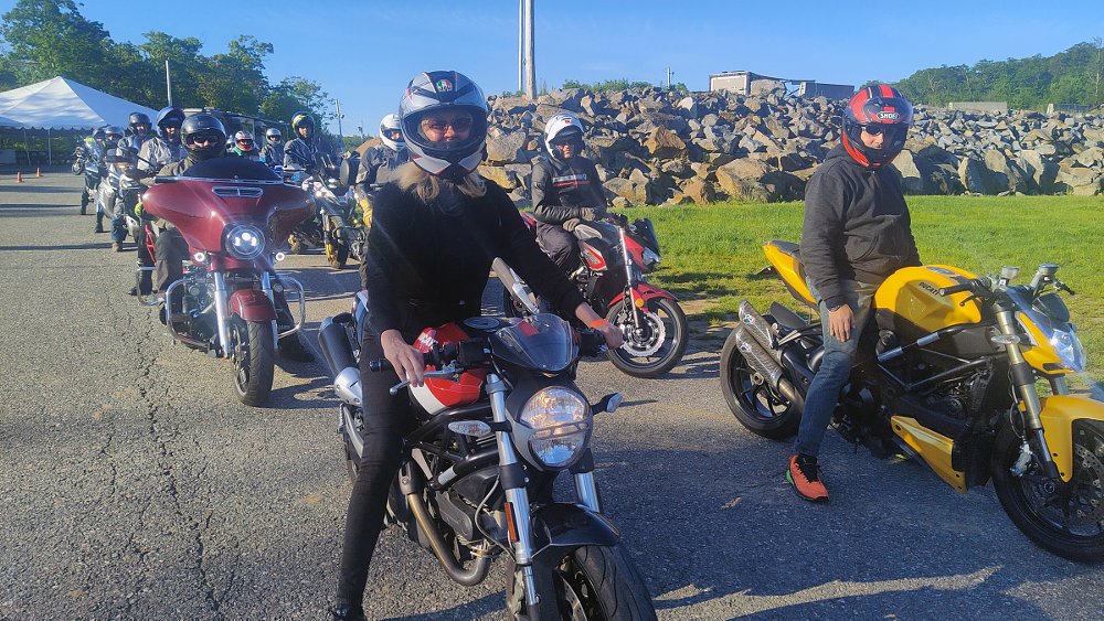 riders lined up for tech inspection on their motorcycles
