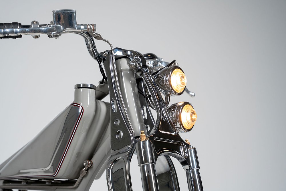 close view of the two small headlights in chrome shells