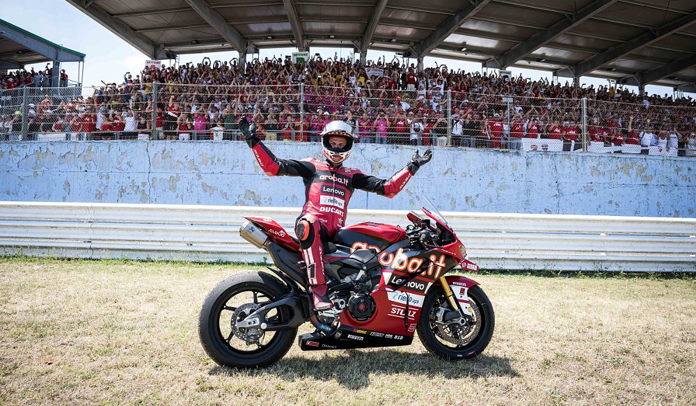 Bulega celebrates his win in front of grandstand full of fans