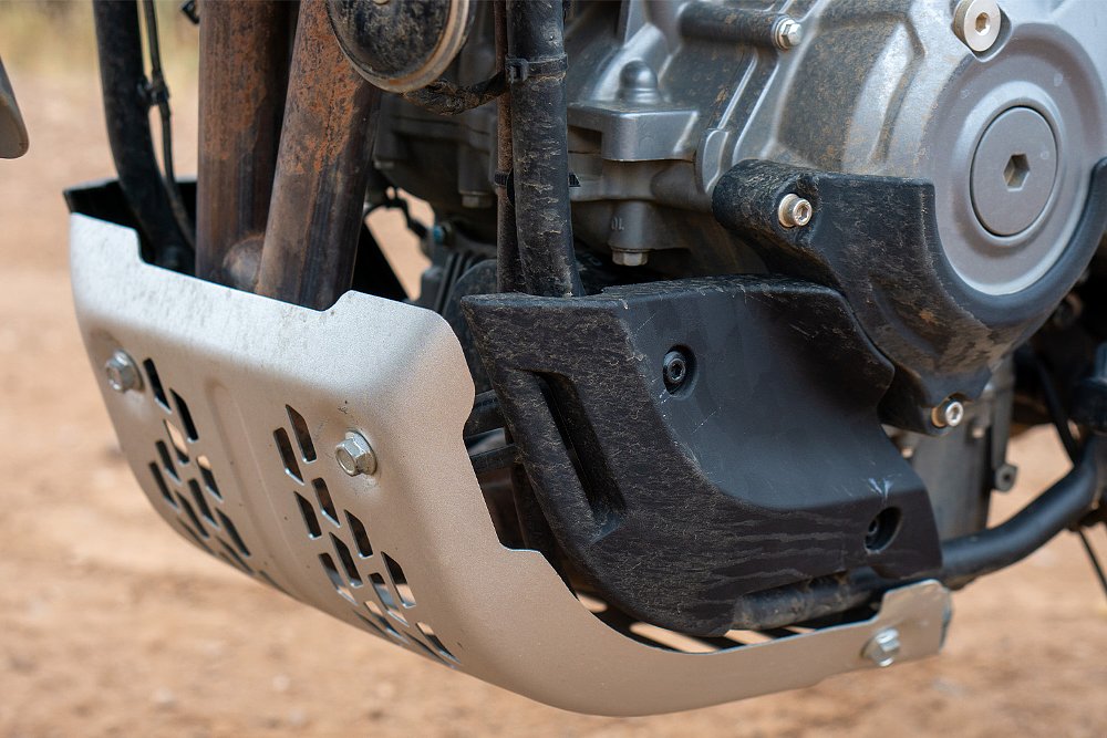 A close-up of the Ibex 450's stock sump guard and side plates.