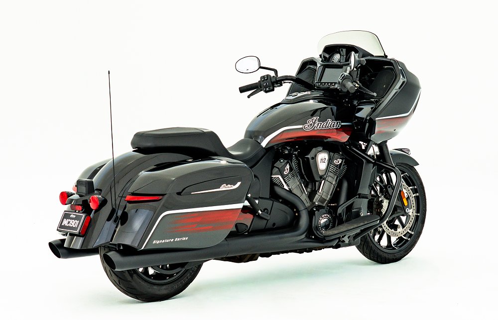 studio photo, rear three-quarters view of the black Indian touring motorcycle with complex red paint accents