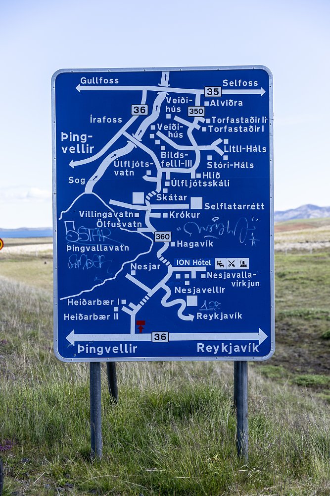complex blue road map sign in the Icelandic countryside