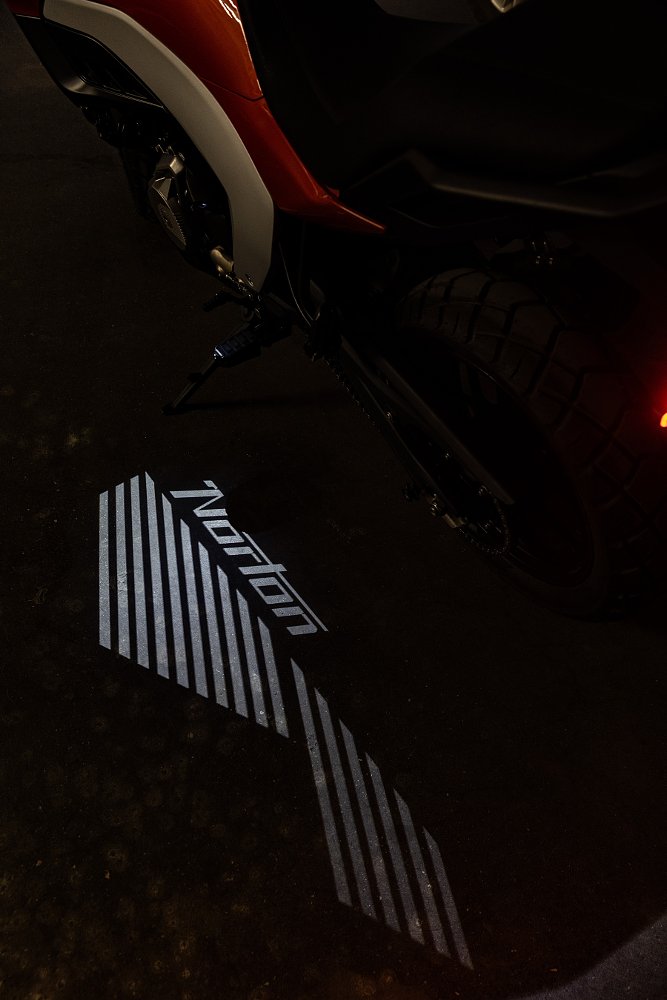puddle light showing Norton name on the ground