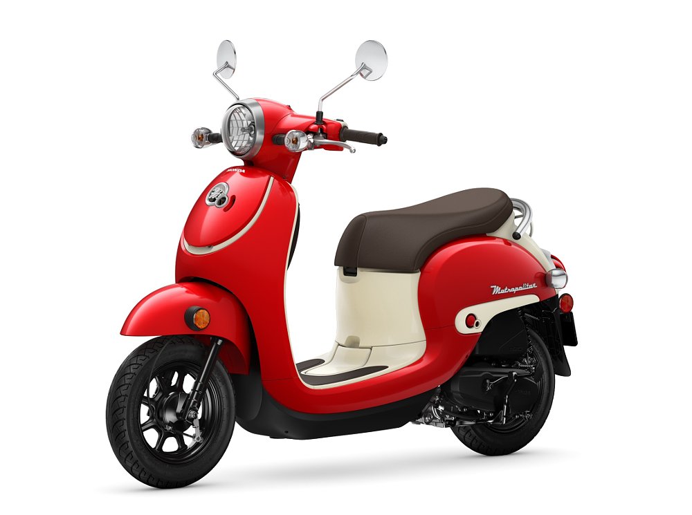 studio photo of a small Honda Metropolitan scooter in red and cream colors