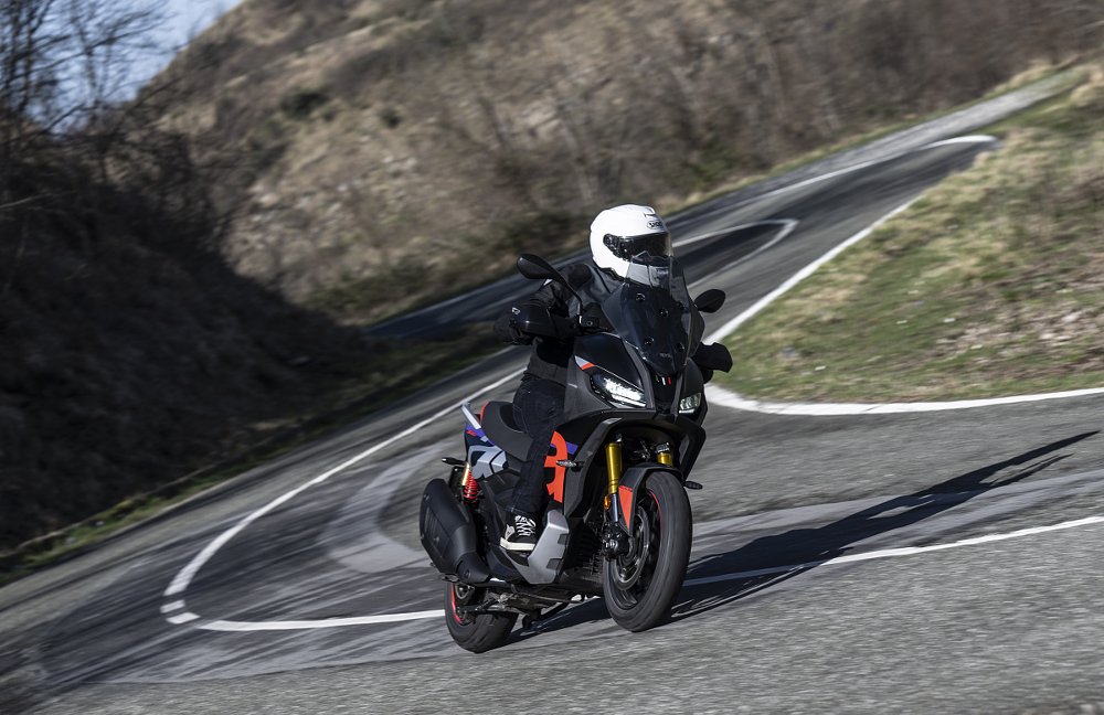 rider on an Aprilia SR GT 400 scooter on a curving country road