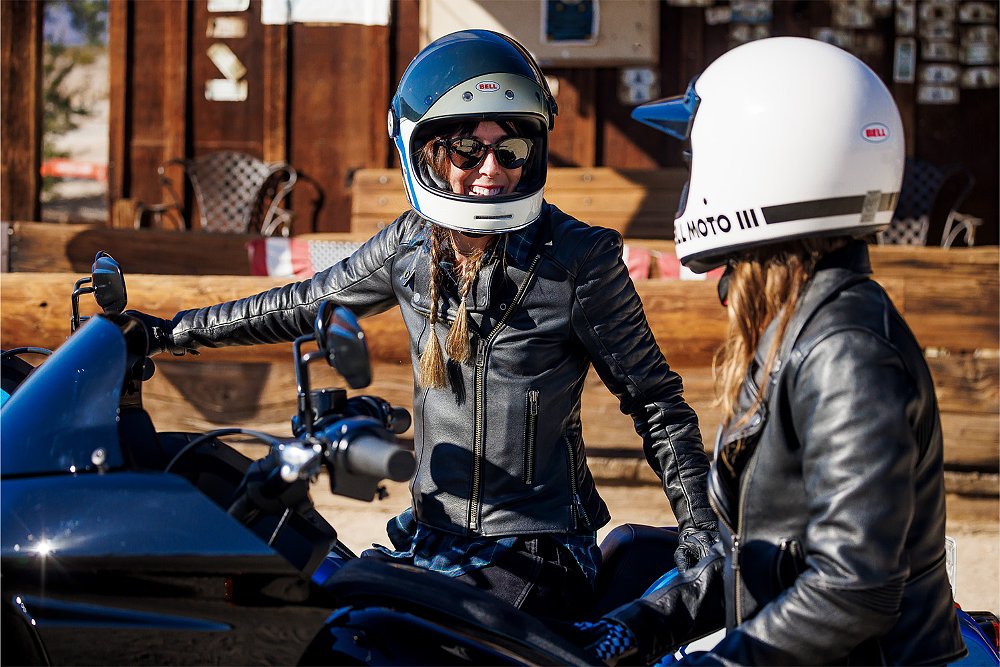 Ashmore Ellis converses with a fellow rider while mounted on a Harley-Davidson.