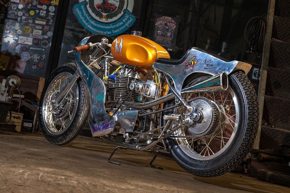cafe racer style motorcycle in gold and yellow with unpainted aluminum parts
