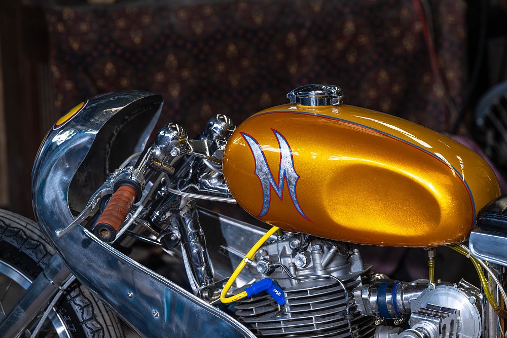 close view of the gold tank with knee cutouts and part of the polished aluminum fairing