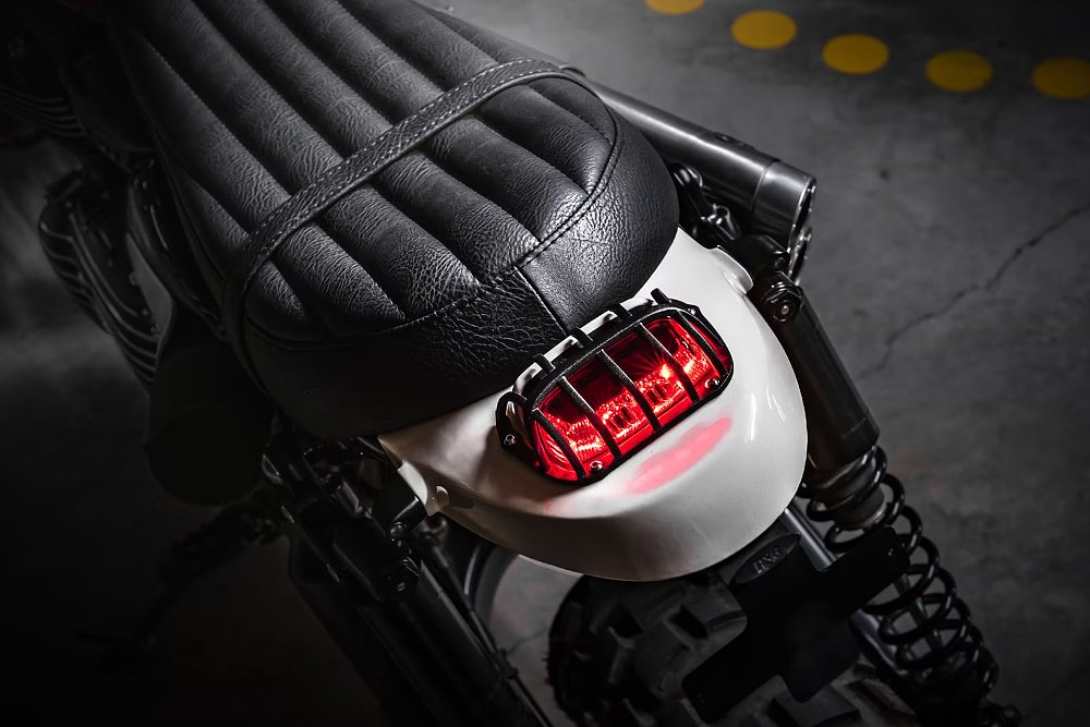 close view of slim tail section with small tail light covered with protective wire mesh