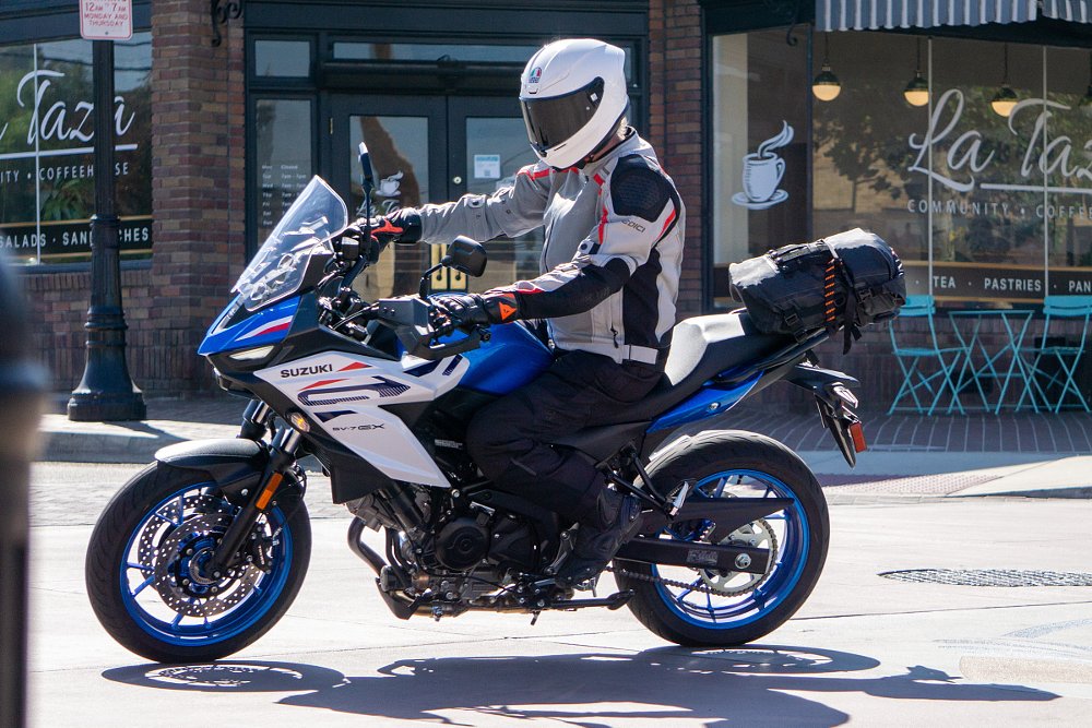 riding the SV-7GX in the city past a coffee shop